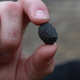 Meteor hunter Robert Ward displays a piece of a meteorite found in Lotus, California believed to between 4 to 5 billion years old.